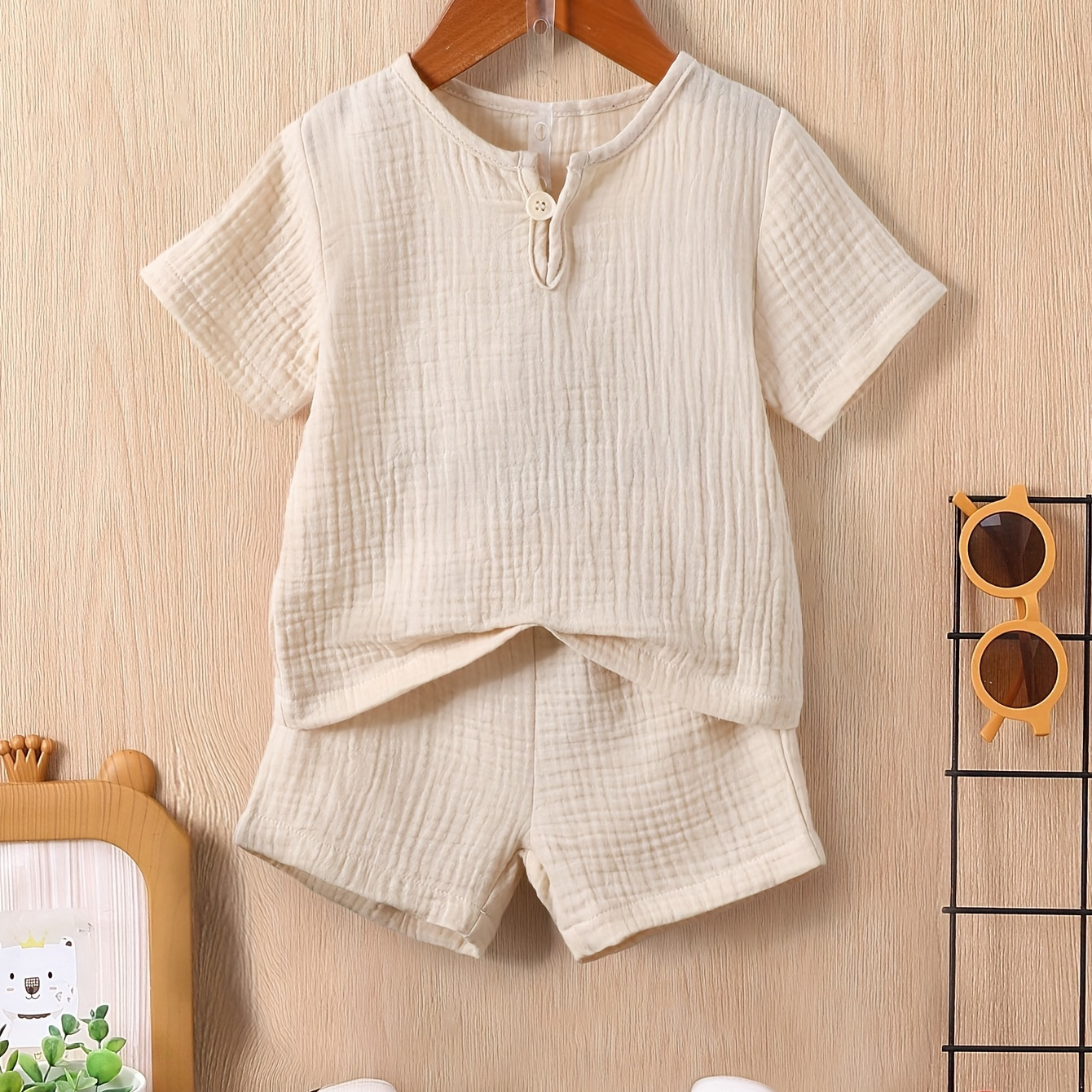 2pcs Baby Boys Summer Outfit, Beige Textured Retro Single Button Short Sleeve Round Neck T-shirt & Elastic Waist Double Layer Textured Heart Print Shorts Set, Casual Style For Toddler Boys, Muslin
2pcs Baby Boys Summer Outfit, Beige Textured Retro Single Button Short Sleeve Round Neck T-shirt & Elastic Waist Double Layer Textured Heart Print Shorts Set, Casual Style For Toddler Boys, Muslin