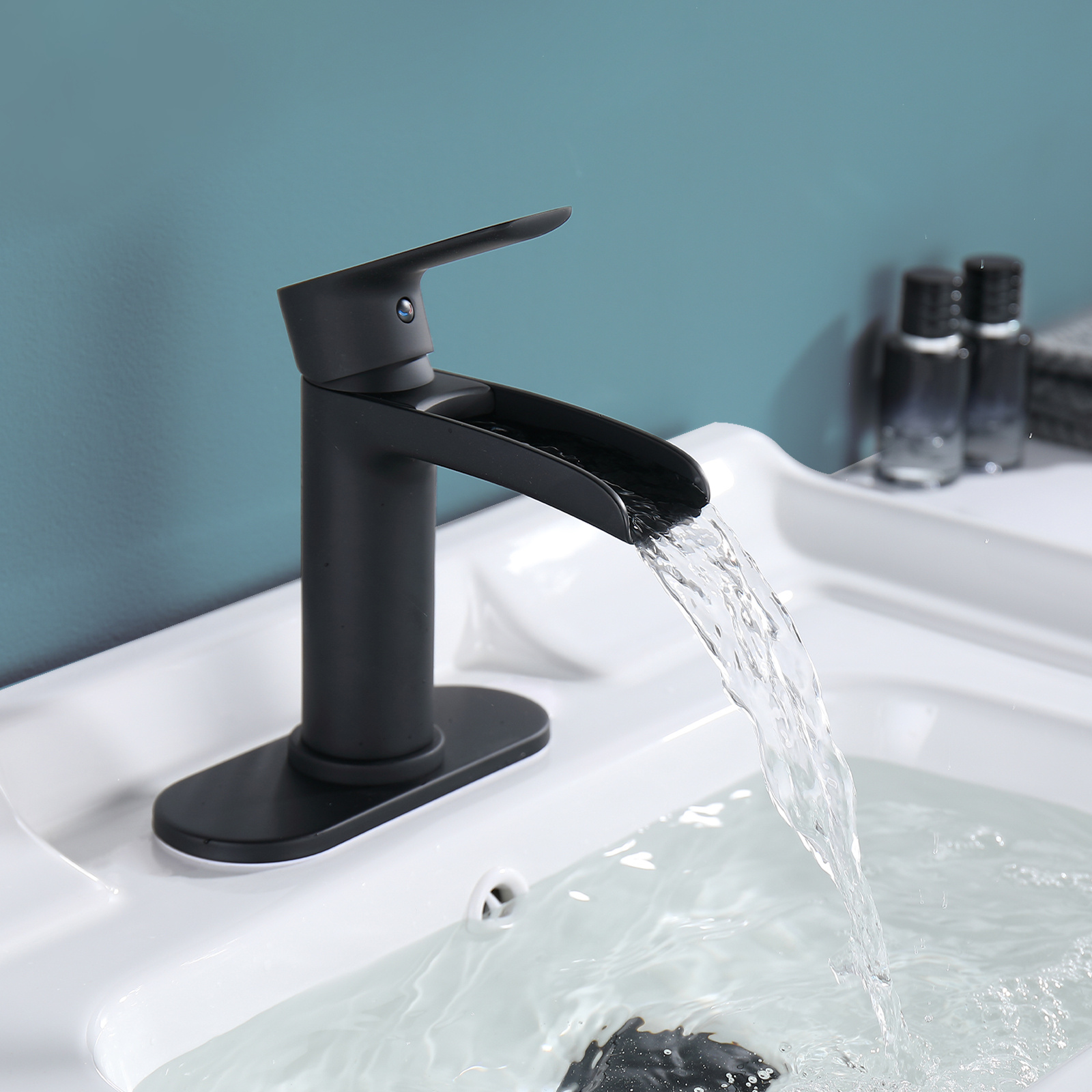 

Waterfall Single Hole Single Handle Low-arc Bathroom Faucet With Deckplate Pop Up Drain Assembly In Matte Black Features A Copper Inner Liner.