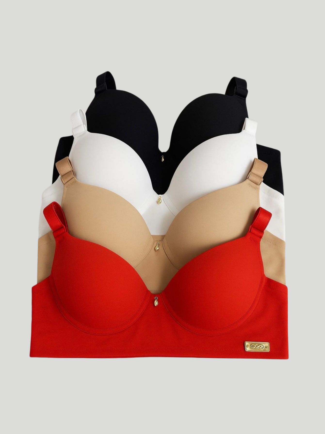 Conjunto de sutias com bojo nas cores preta, branca, bege e vermelha empilhados