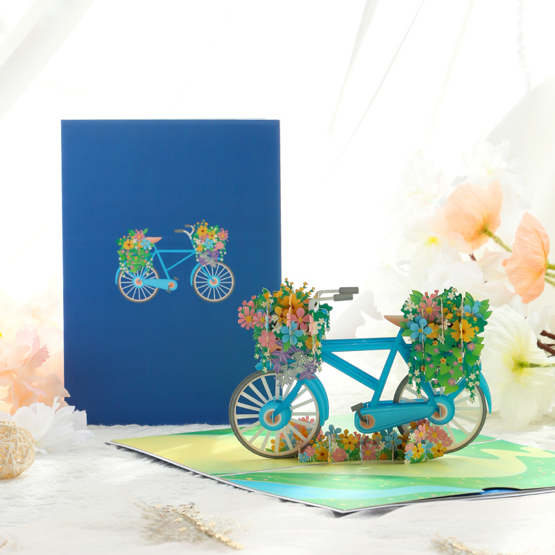Image of A 3d Pop-up Birthday Greeting Card Featuring A Handmade Paper Sculpture Of A Bicycle Flower Cart, Perfect For Birthday Wishes And Messages