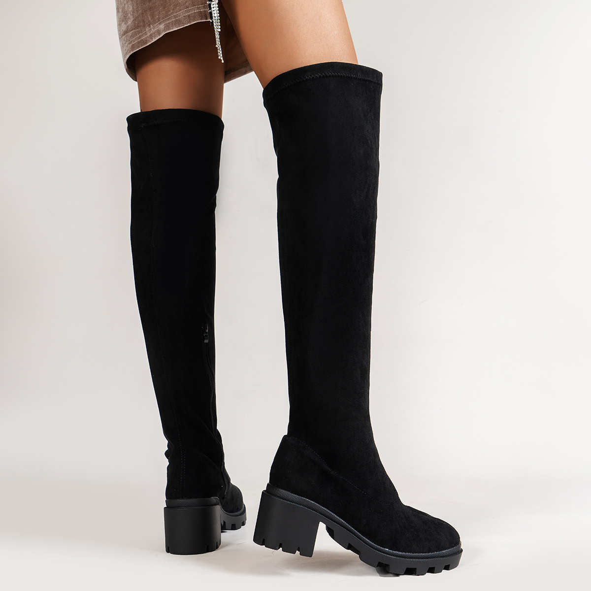 black cleated sole over the knee boots