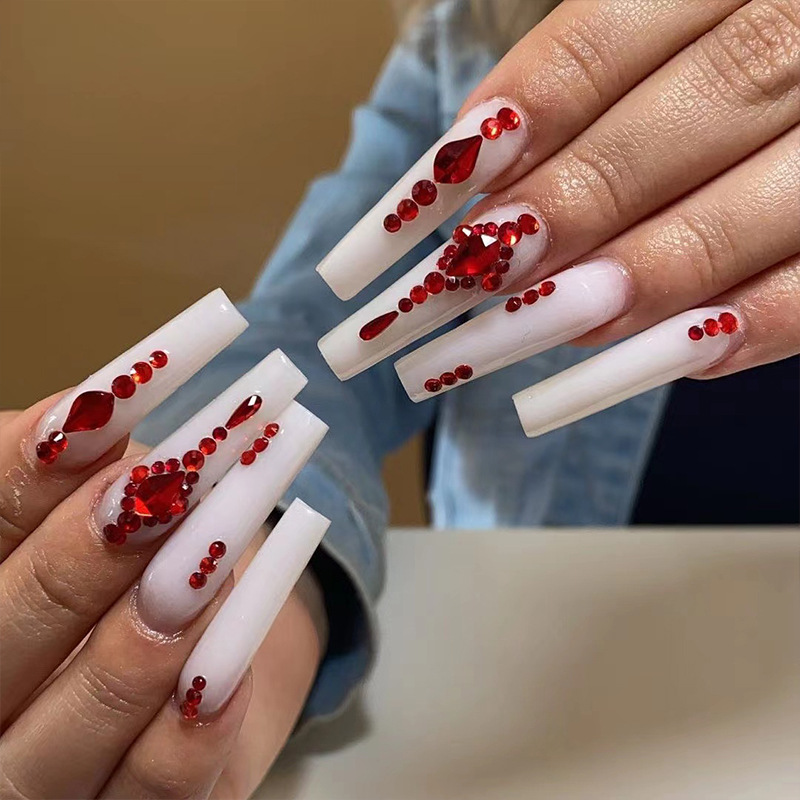 Long red nails with rhinestone are simply gorgeous.