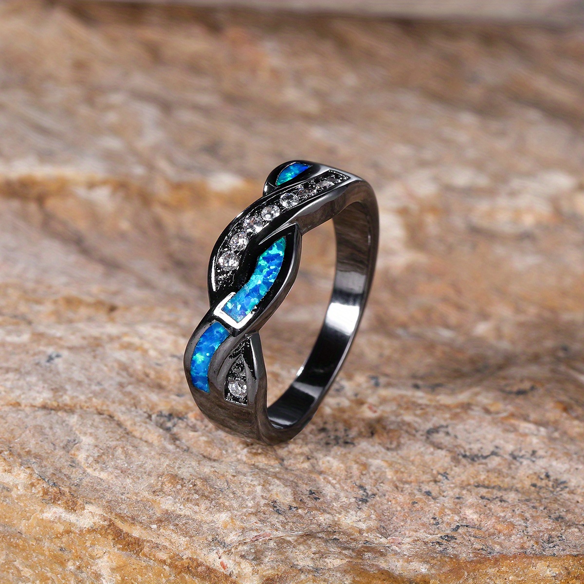 A Stylish Ring Featuring A Wavy Design With Black Golden, Opal, And Zirconia, Exuding A Trendy And Elegant Shimmer.