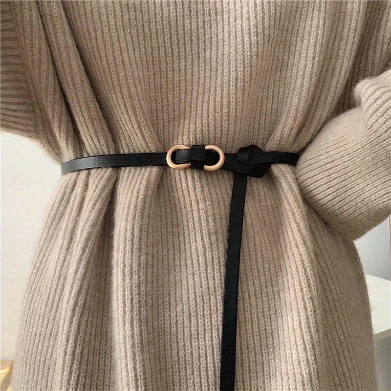 A Stylish Black Belt With A Slim Waist Design, Pairing With Dresses And Sweaters.
