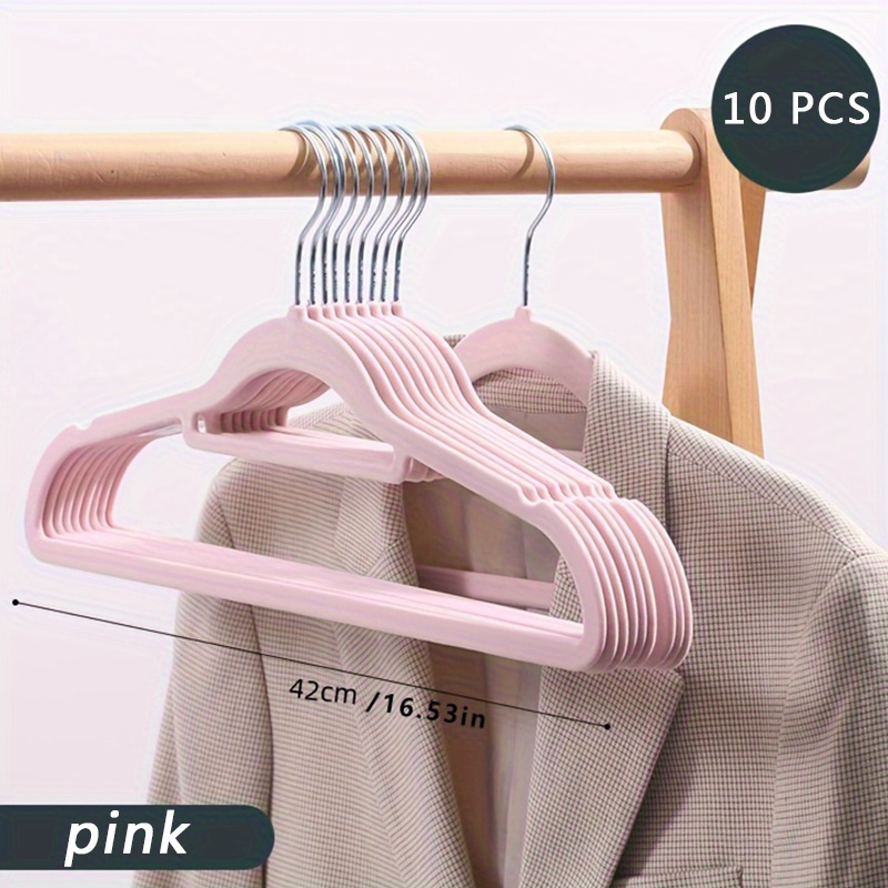 Clothes hanging on hangers in women clothing store