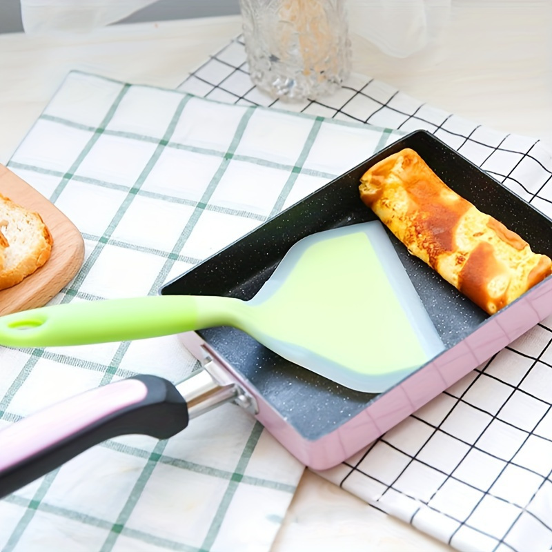 a silicone spatula non stick heat resistant kitchen utensil suitable for cooking stirring and frying ideal for pancakes steaks and barbecue grills