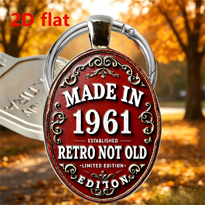 TEMU 2d Flat, A 2d Flat Oval Keychain Featuring A "1961 Edition" Themed Design. It Features Red Background With White Lettering, An Ornate Decorative