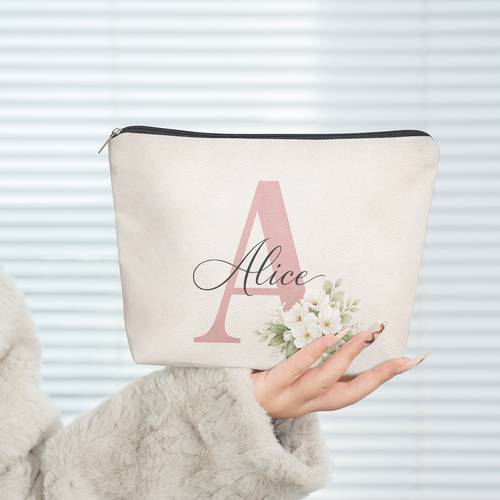 a makeup bag featuring a floral and letter combination design made of linen with a zipper a toiletry bag a cute and stylish wallet and a portable storage pouch travel and as a holiday gift