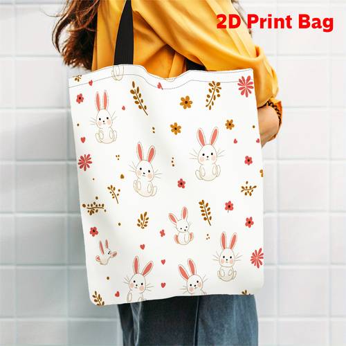 1 2d printed tote bag featuring an adorable design of rabbits and flowers its reusable and a versatile handbag suitable for casual work and shopping