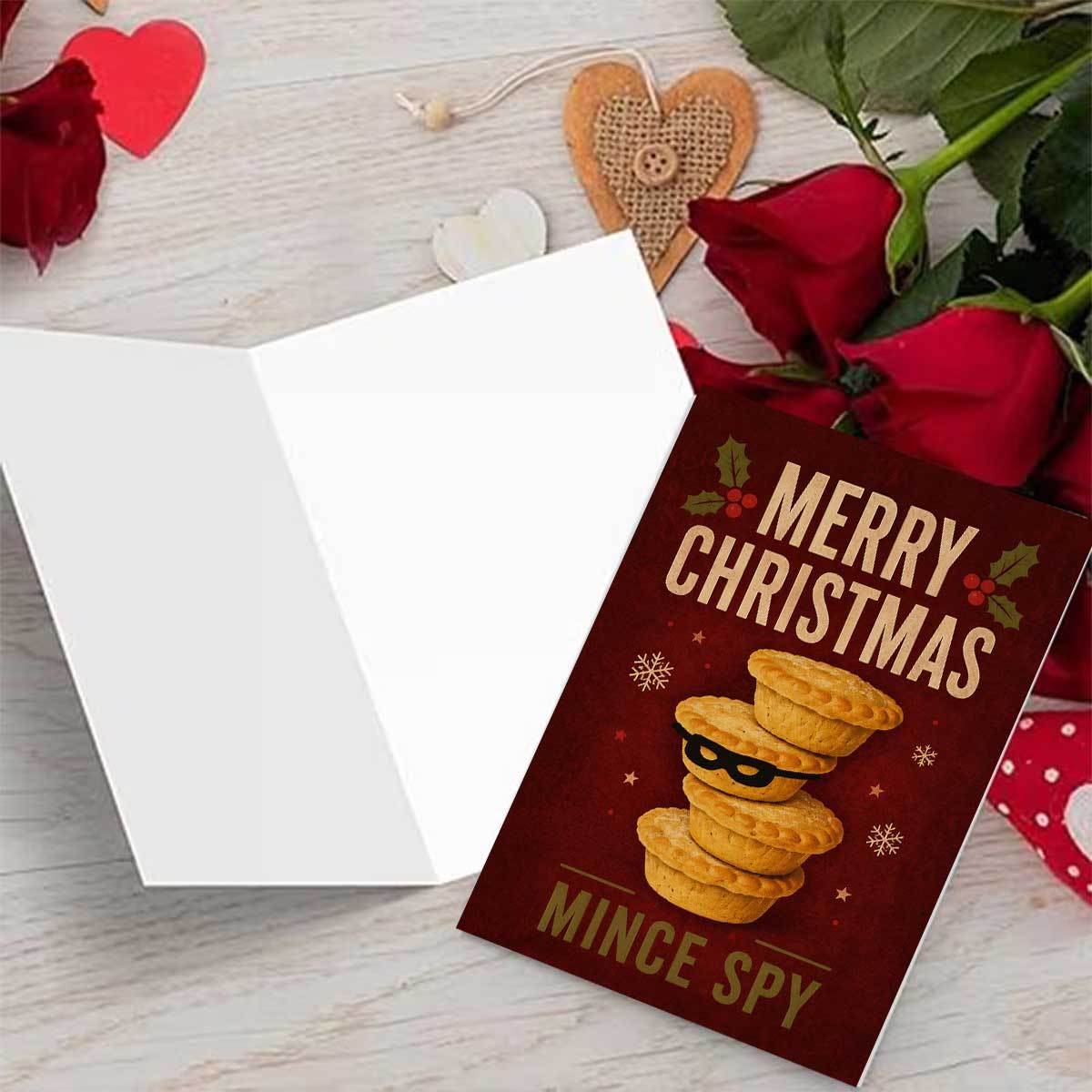 1  creative meat pie christmas card   background with stacked meat pies wearing black eye masks snowflakes and stars merry christmas and mince   text suitable for friends with envelope