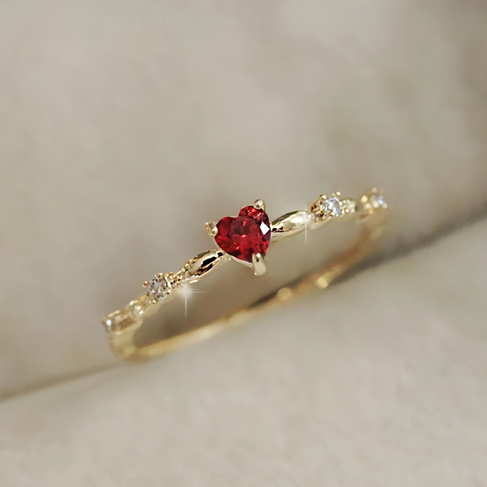 

Elegant Golden-tone Ring With Red Heart-shaped Zirconia & Clear Accents - Romantic Copper Jewelry For Women, Ideal For Weddings, Engagements, Anniversaries, Valentine's Day Gifts