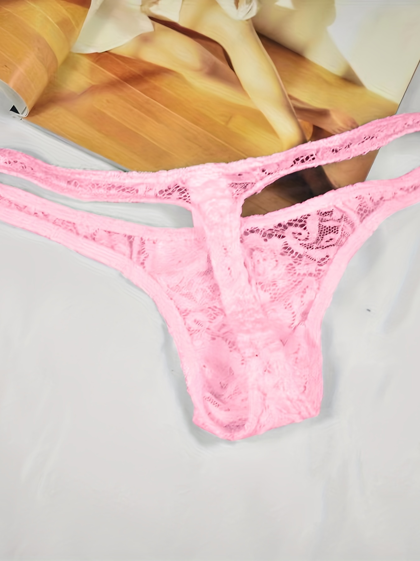 Female, Pink, Used Panties String on the Bed. Fetish. Stock Photo