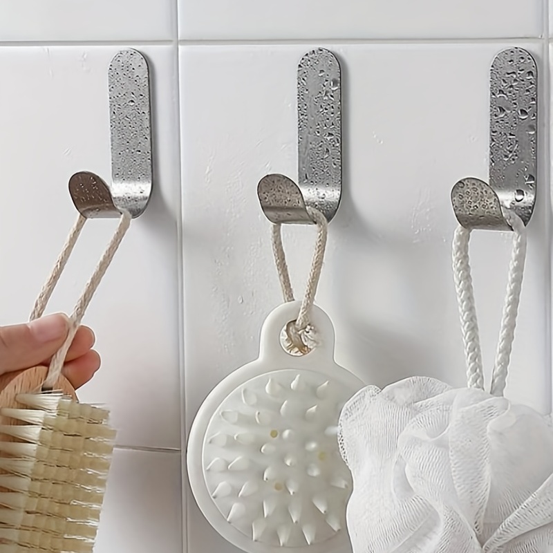 Los ganchos de pared para colgar toallas en el WC más vendidos en   son adhesivos y de acero inoxidable