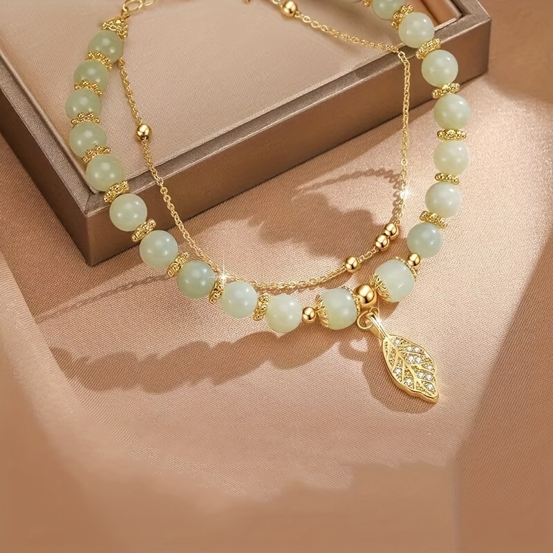 Golden Tone Leaf Charm Bracelet with Green Beads