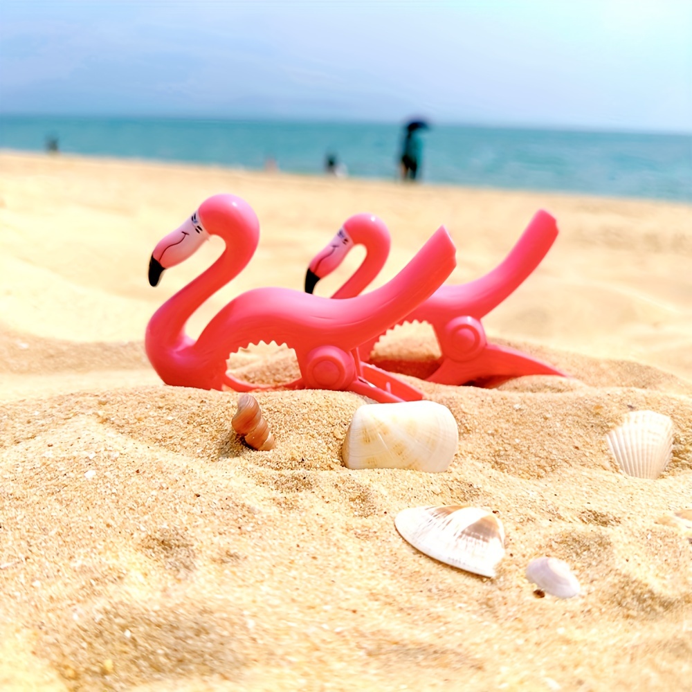 Toalla de playa rosa con pinzas para la arena