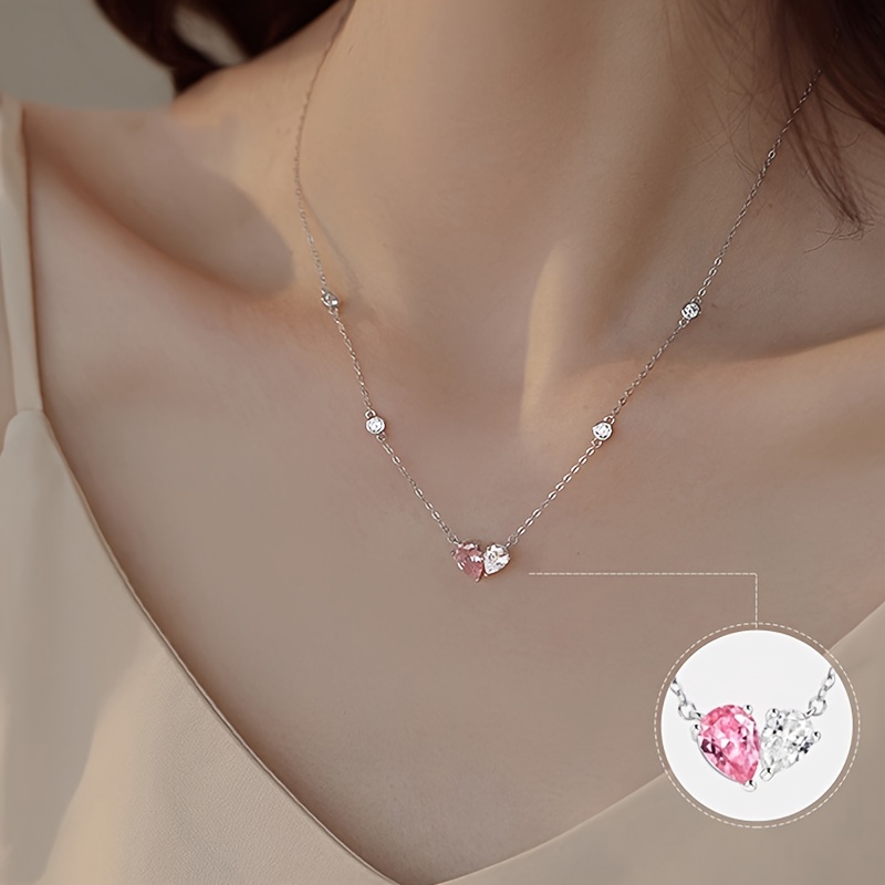 Gold necklace with tiny heart shape pendant and pink Zircons