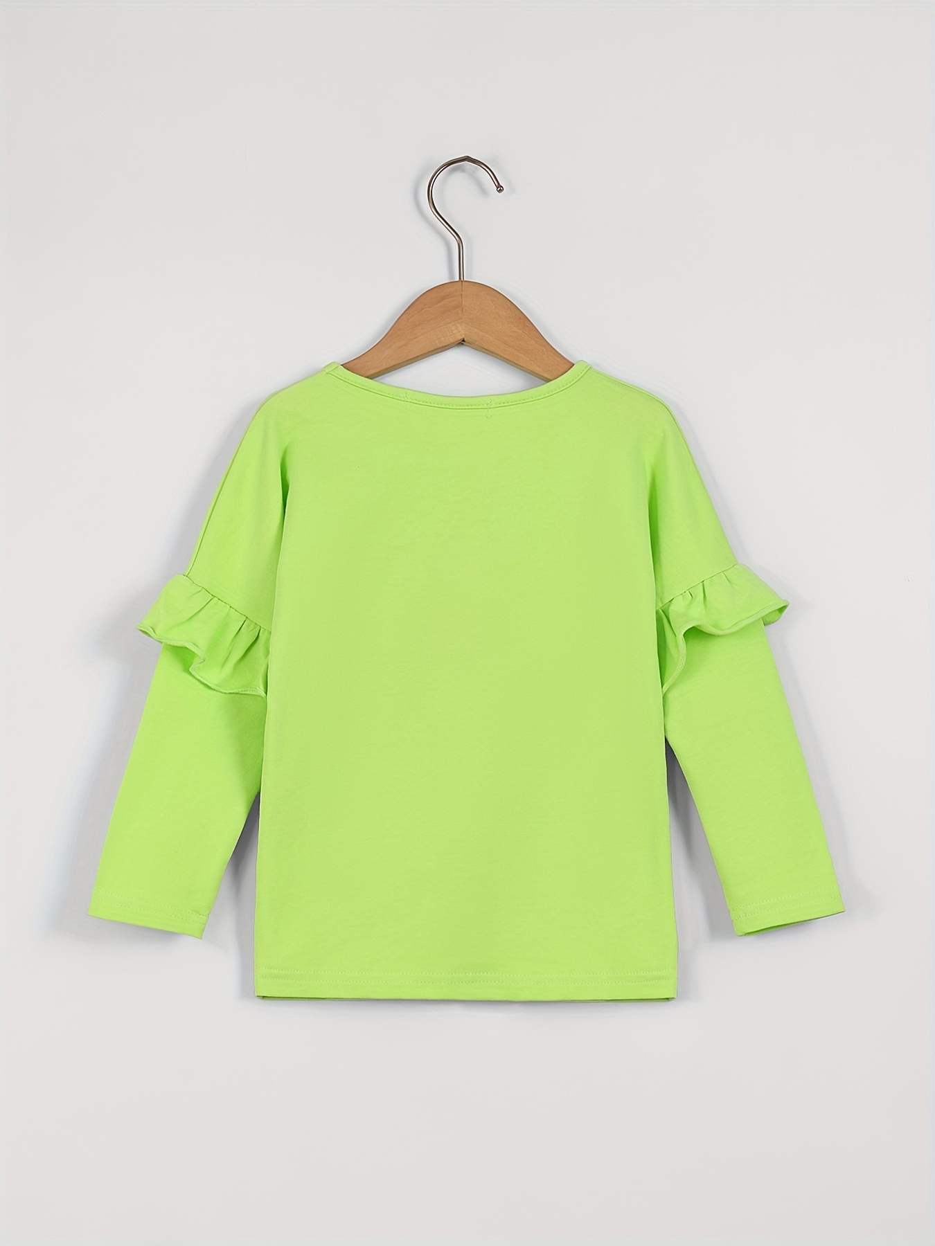Camiseta estampada con volantes en verde de niña
