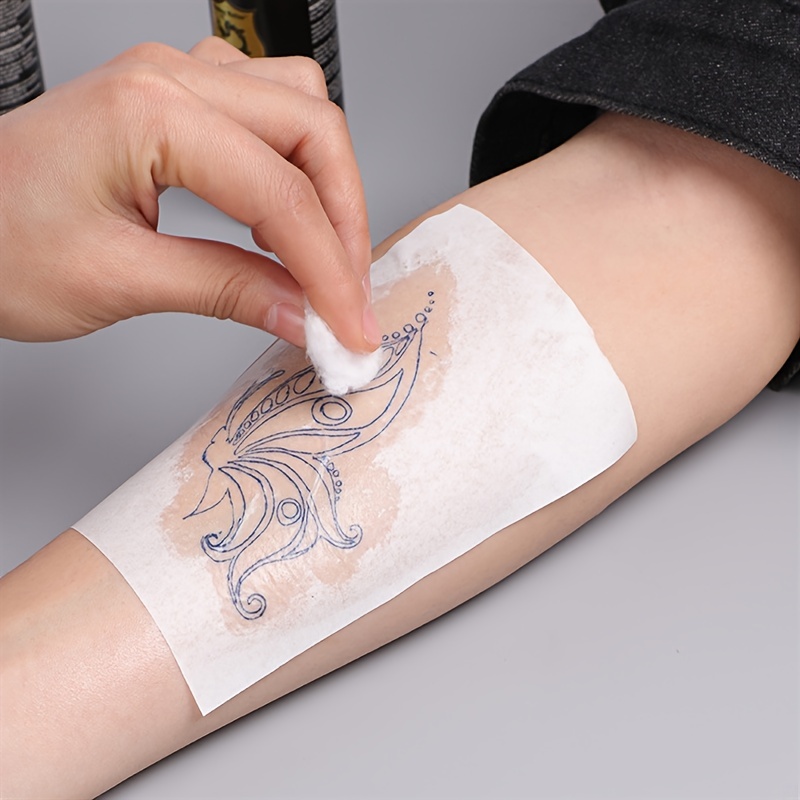 Hand Holding Temporary Tattoo Paper Isolated Soft White Background