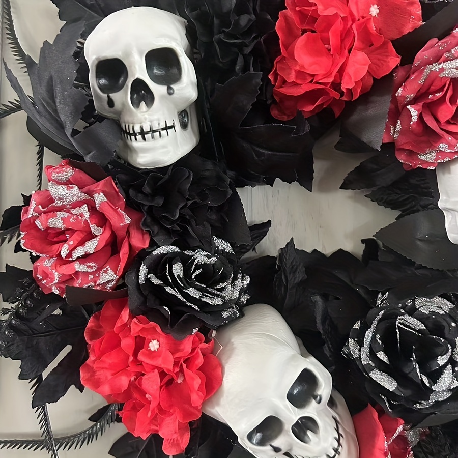 Skulls crowns and faded red roses on a dark black wrapping paper