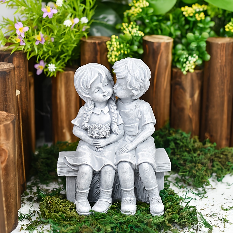 

Statue of a young couple sitting on a bench, sharing a kiss, perfect for decorating gardens, yards, patios, and indoor spaces.
