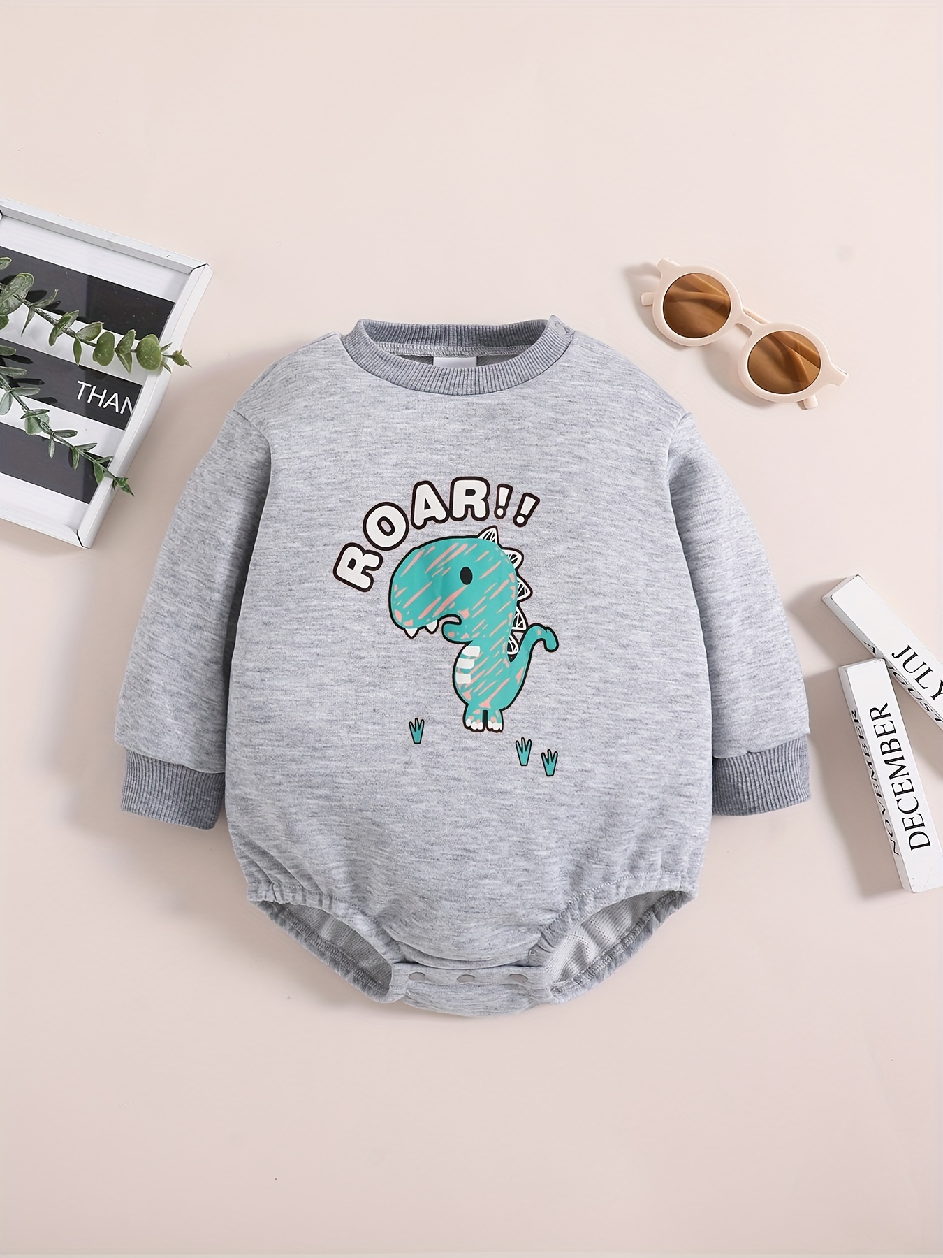 Long-sleeved jersey onesie with dinosaur print