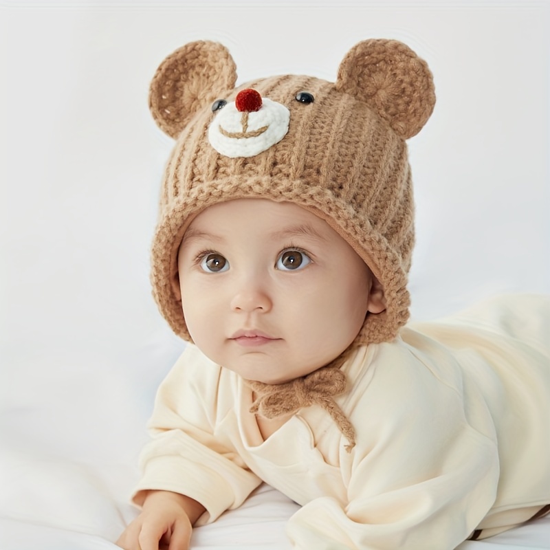 gorro con orejeras para bebé con oso de dibujos animados, tejidos con  pompón de piel sintética para niño y niña con protección para los oídos