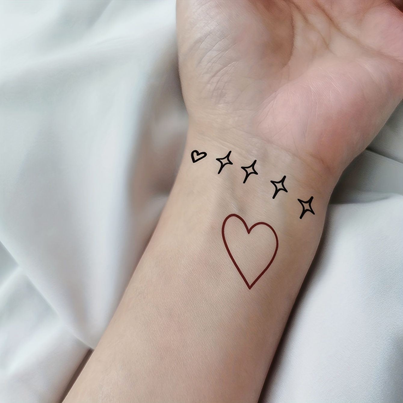 red heart tattoo on wrist