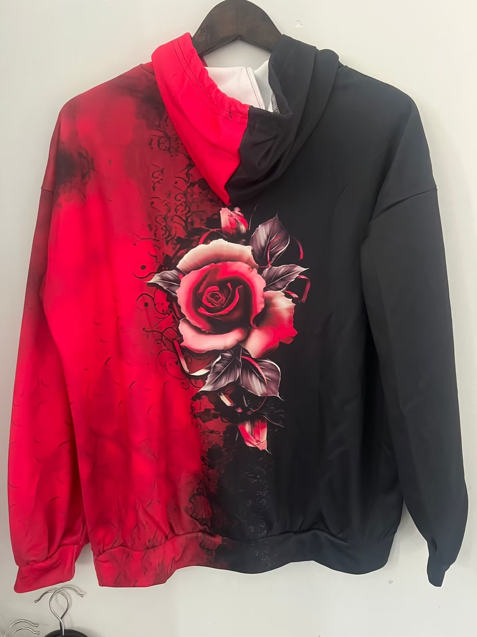 Black hoodie with online red roses on sleeves