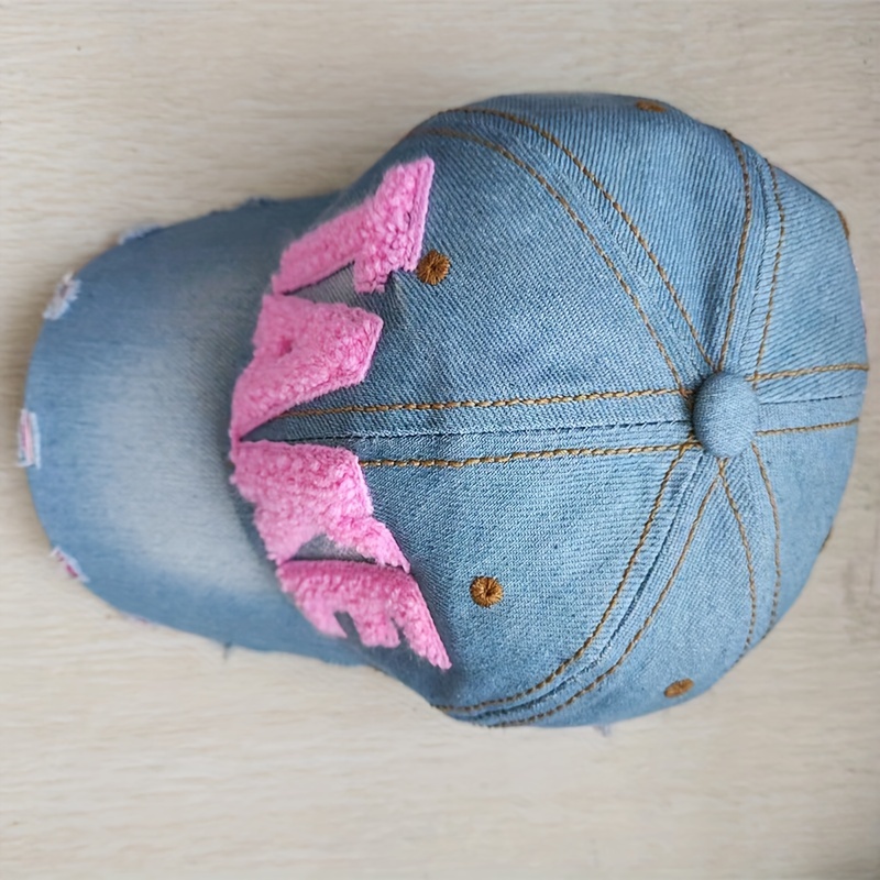 Hot pink beanie with ripped jeans