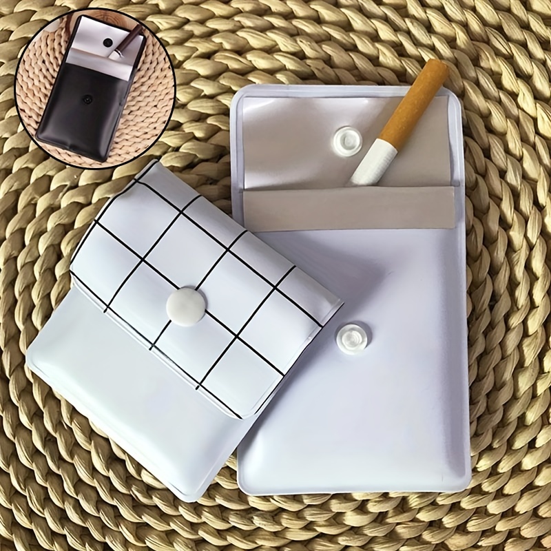 a glass and a cigarette Hands of alcoholic man holding a glass with alcohol drink with smoking  cigarette in the ashtray black and white Stock Photo