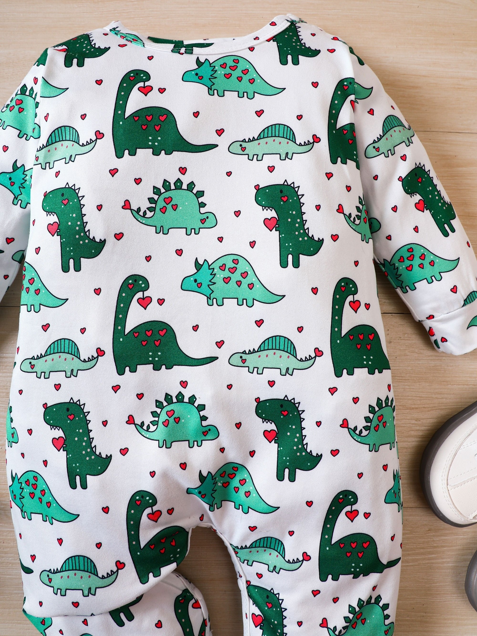 Long-sleeved jersey onesie with dinosaur print