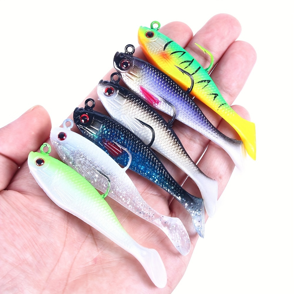 Jig silicone fishing lures in plastic tackle lure box. Silicone