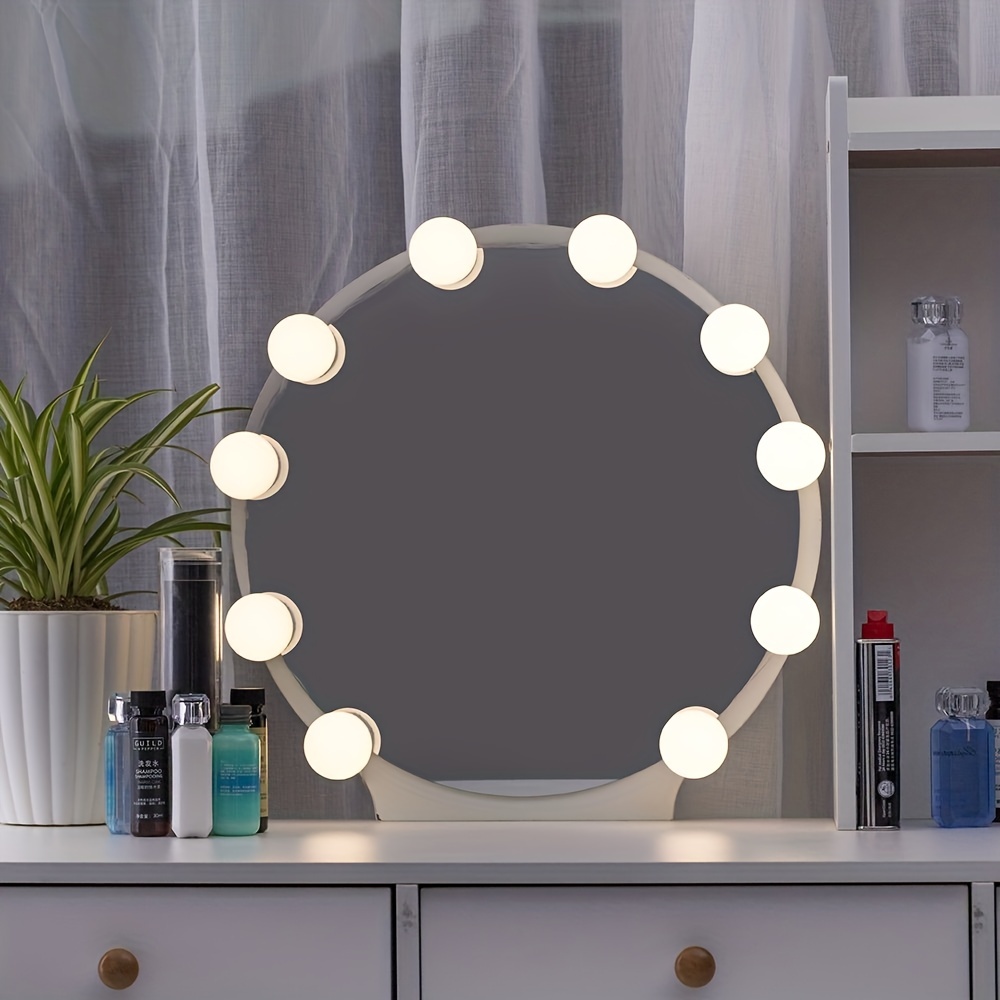 Mesa de tocador de maquillaje con espejo iluminado y tira de