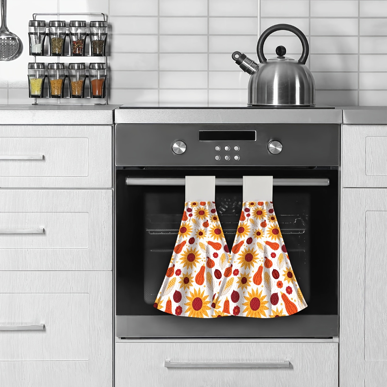 Tea towel or drying cloth hanging on an oven door handle of a