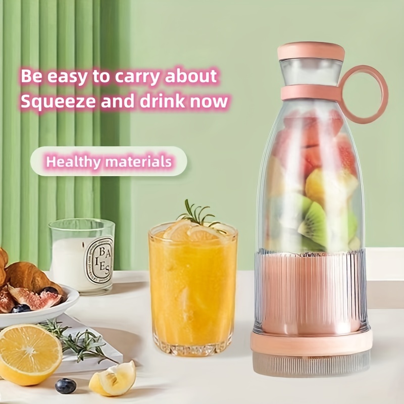 Electric blender with fresh homemade fruit smoothie and group of