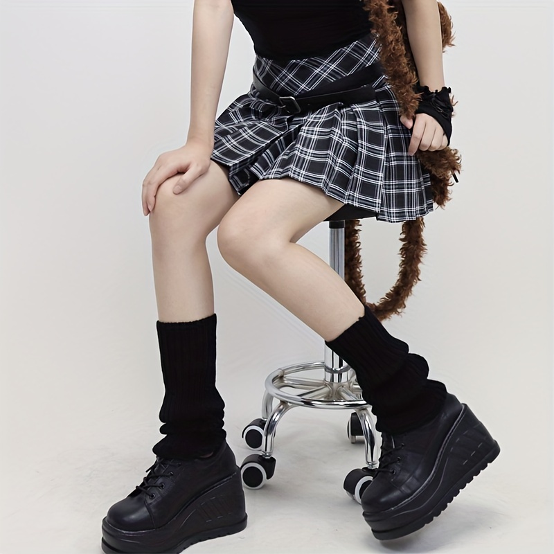 Woman S Legs In Schoolgirl Plaid Skirt, White Stockings, And Black