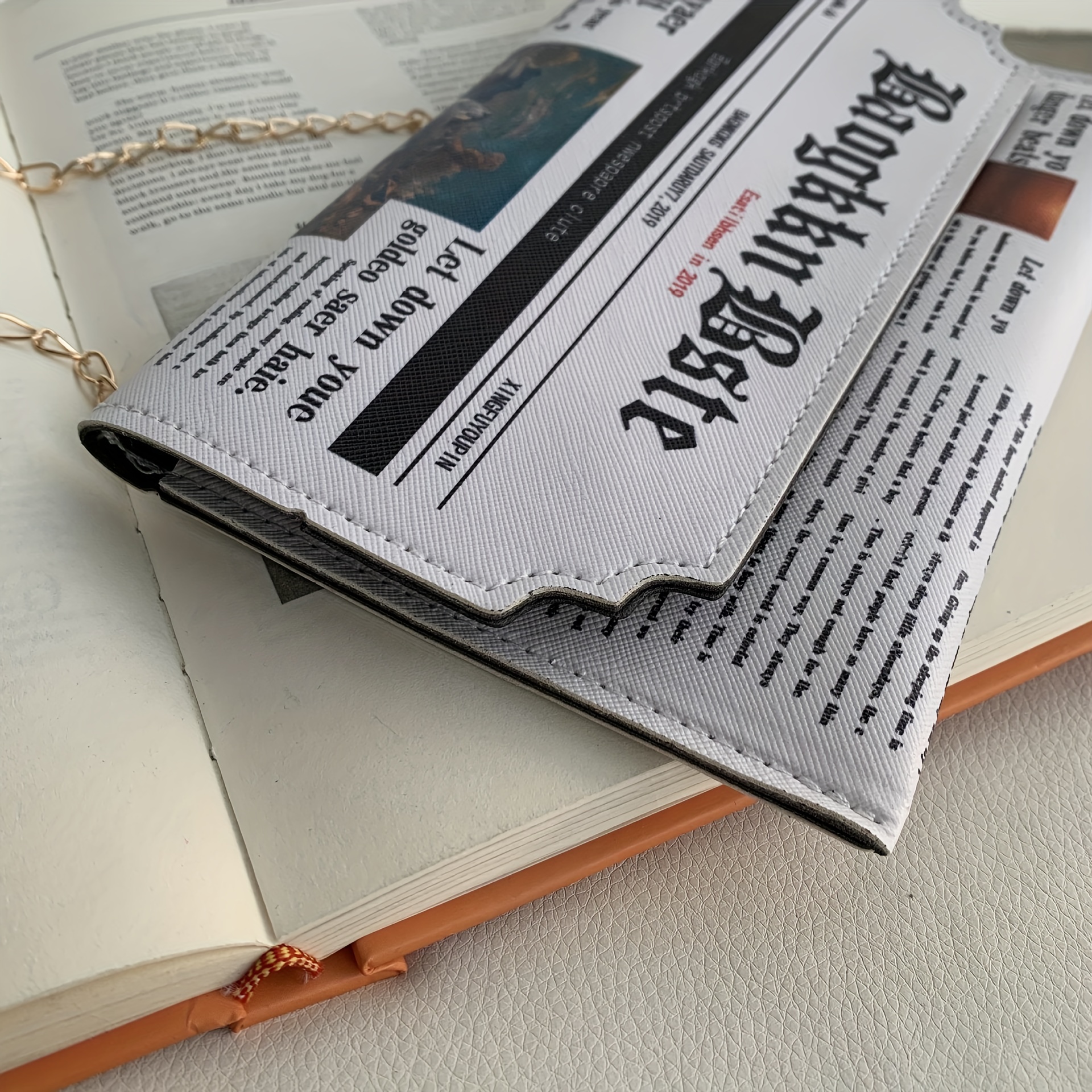 Newspaper clutch hot sale bag