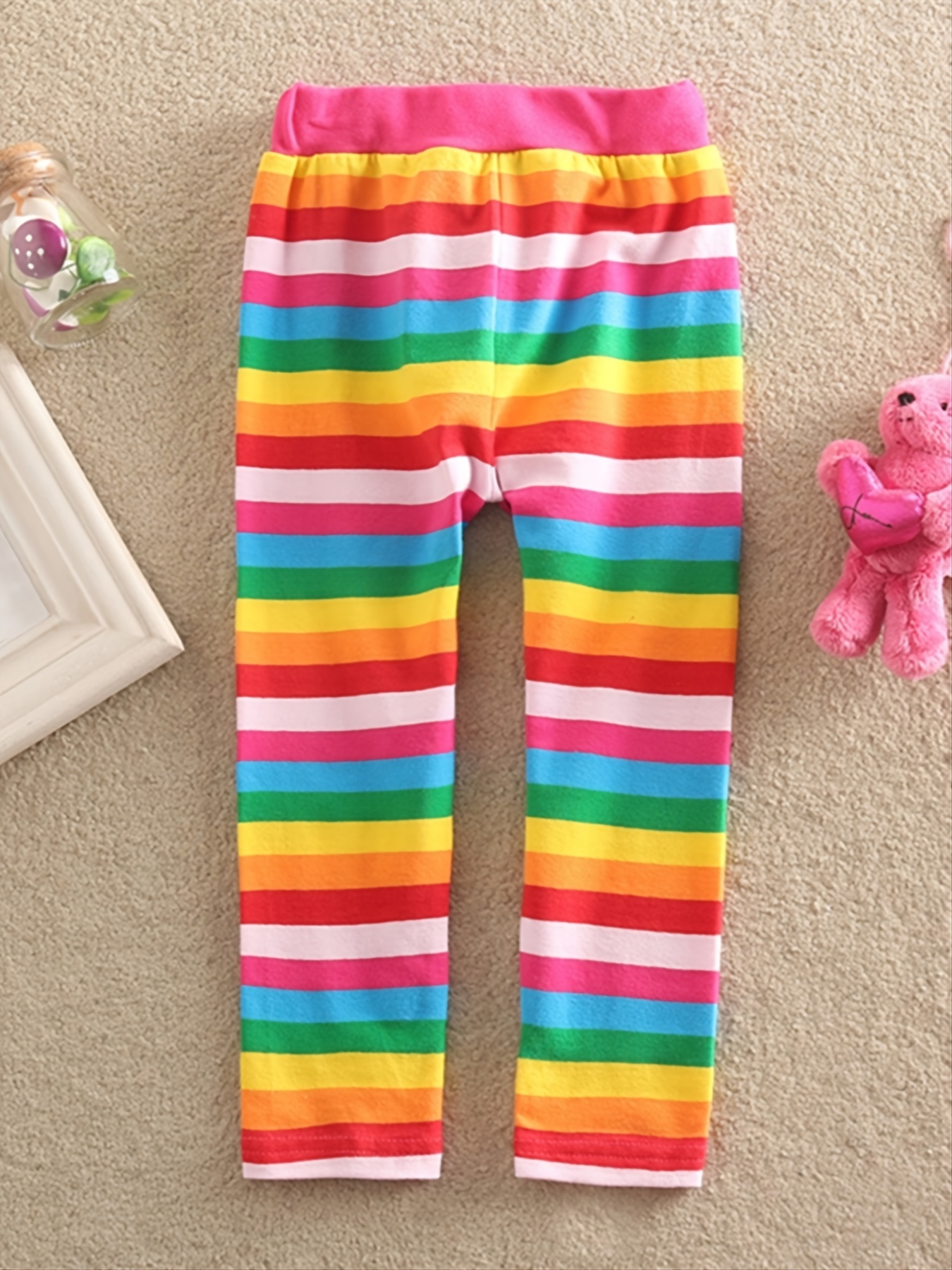 Bright pink rainbow striped leggings