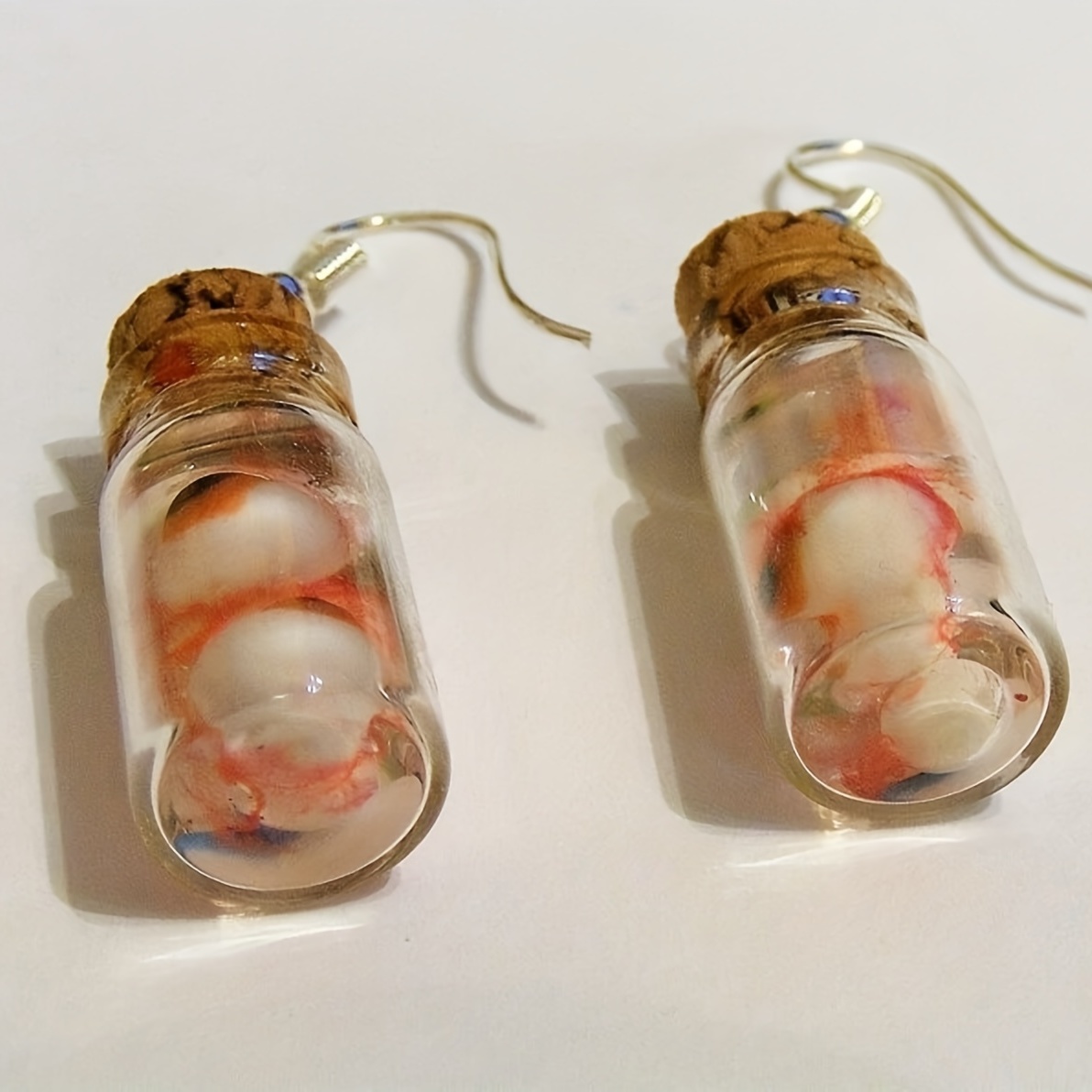 Earrings in glass on sale bottle