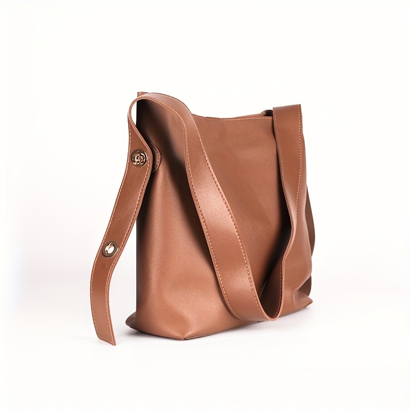 Brown minimalist leather purse with adjustable strap