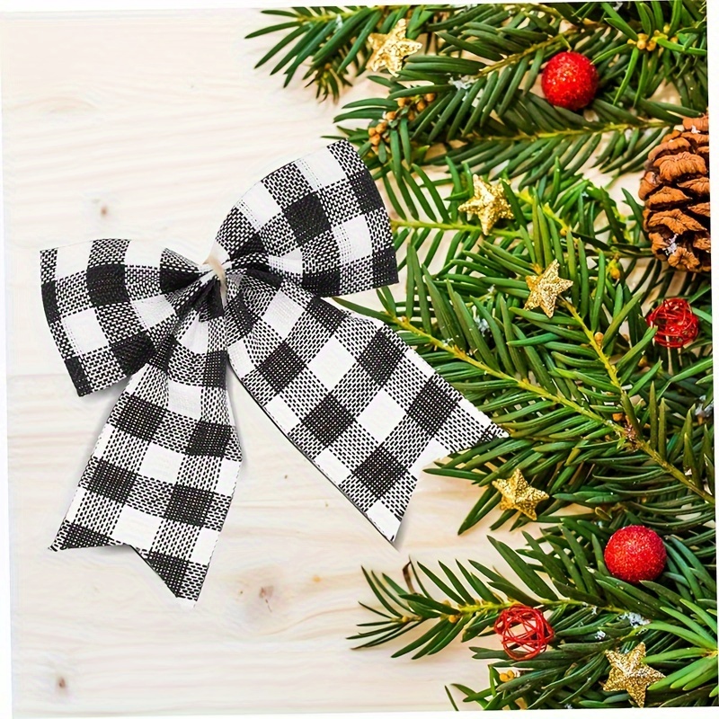 Premium Photo  Black gift wrapped in black paper tied with a red ribbon  and a bow with branches of a christmas tree