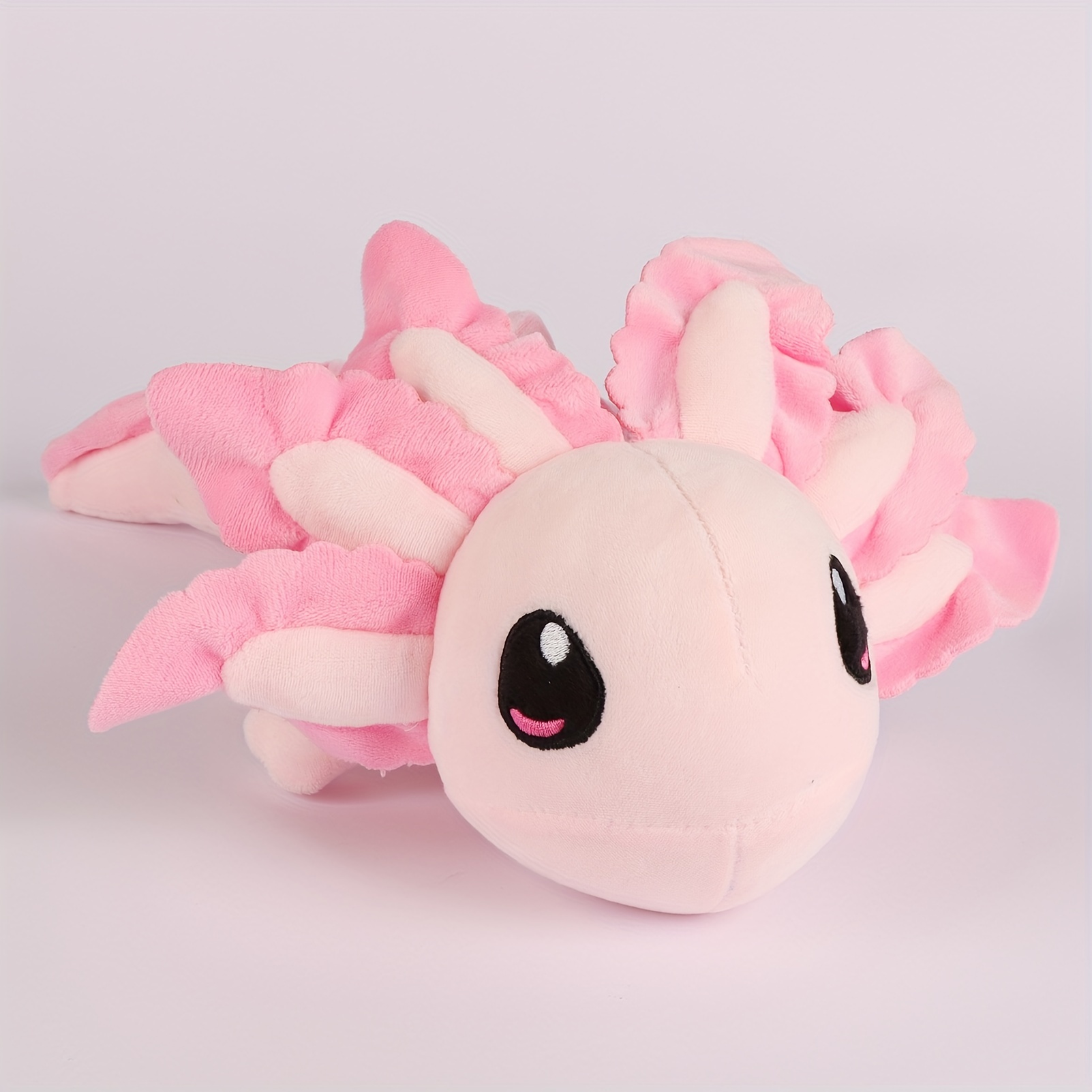 Cute pink plush axolotl. Soft toy plushie axolotl