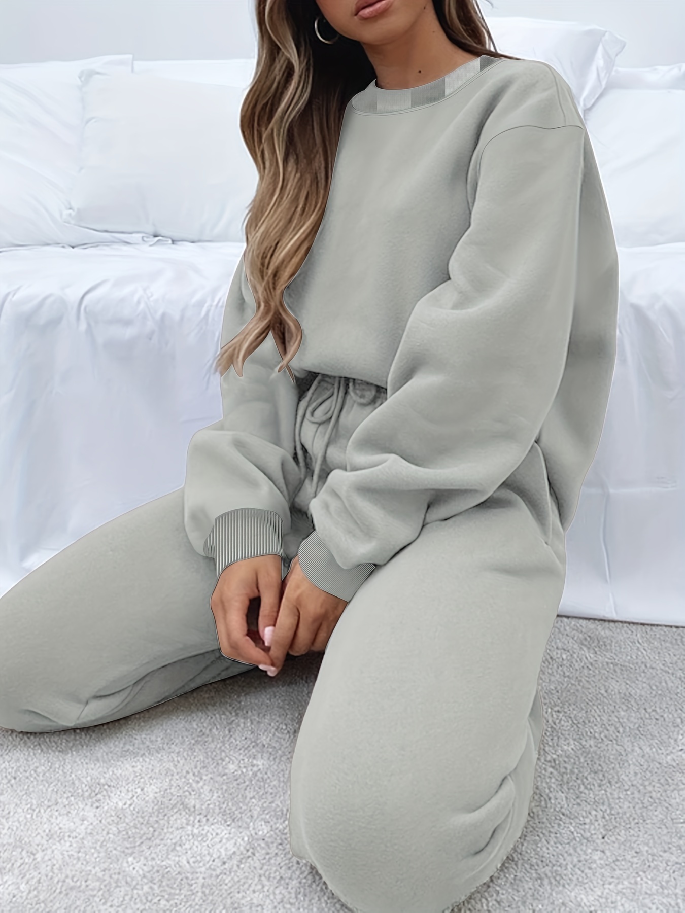 Side view of the loose pullover sweatshirt and relaxed fit pants