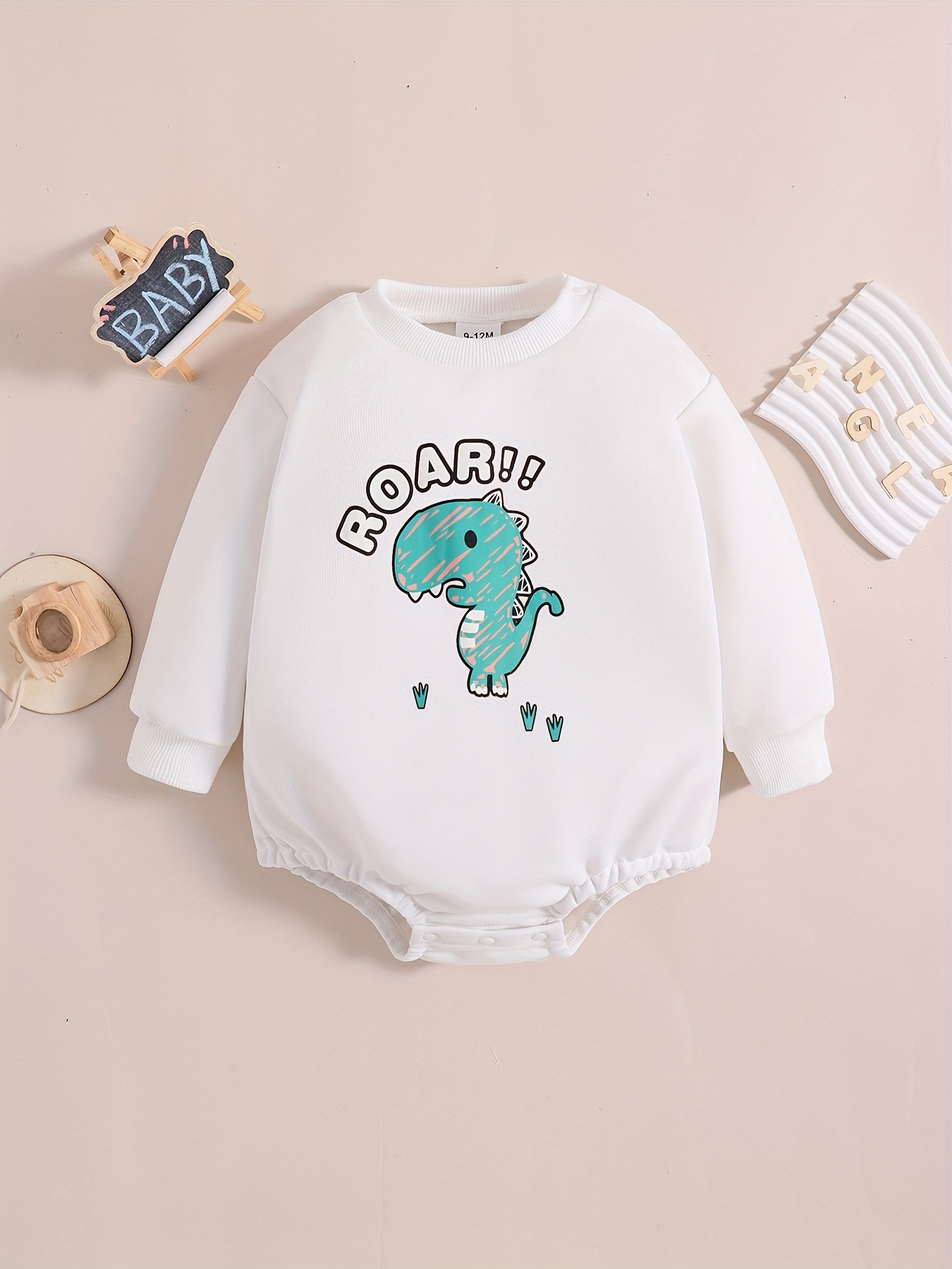 Long-sleeved jersey onesie with dinosaur print