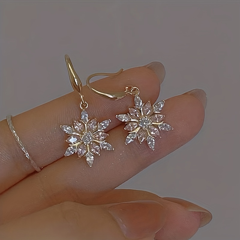 Small Snowflake Shaped Stud Earrings in Gold with Rhinestones | DOTOLY