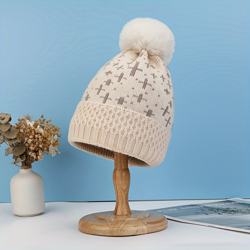 Bonnet beige à pompon pour fille