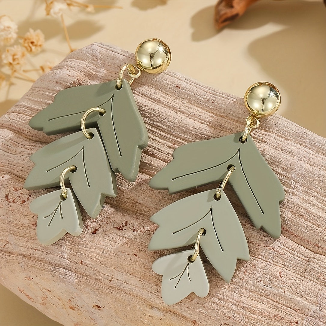 A Pair Of Women's Acrylic Earrings Featuring -layer Leaf Design With Gradient And A Clay Texture