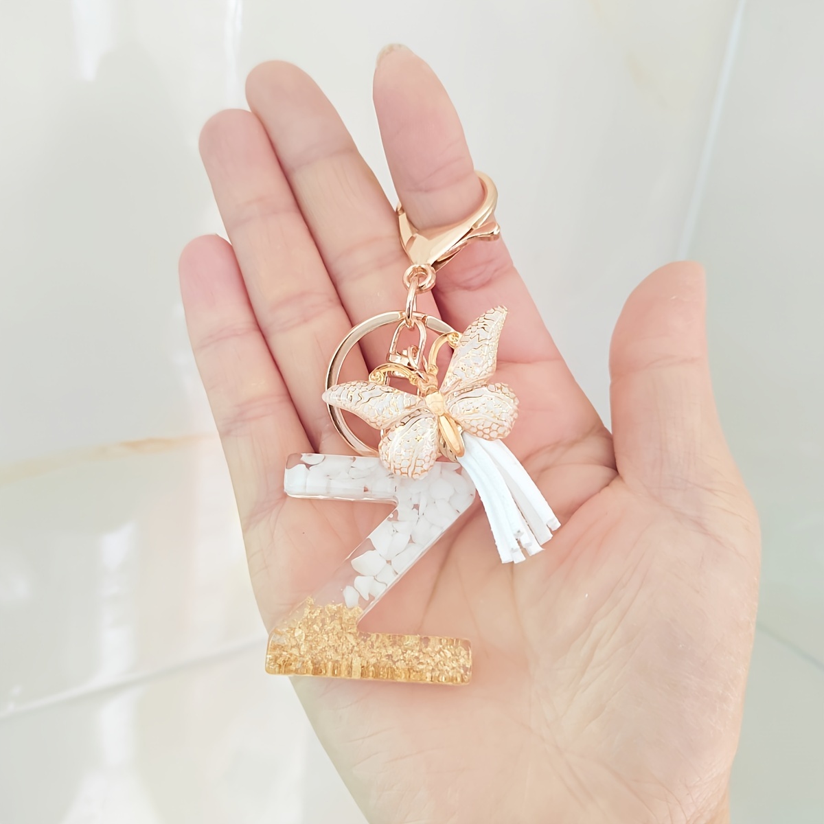 Crafty Angel Art E - Letter - Initial Resin Keychain Aqua solitd Color with Shimmering Mix of Glitter on The Front with Pearls Along with A Décor of Cow Head Along