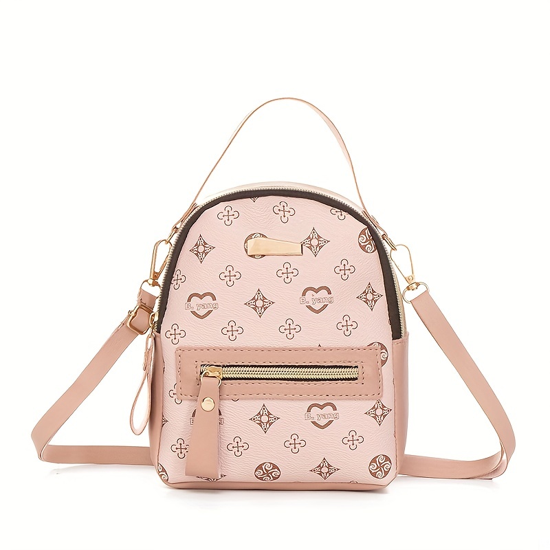Woman holding brown and pink floral leather crossbody bag photo
