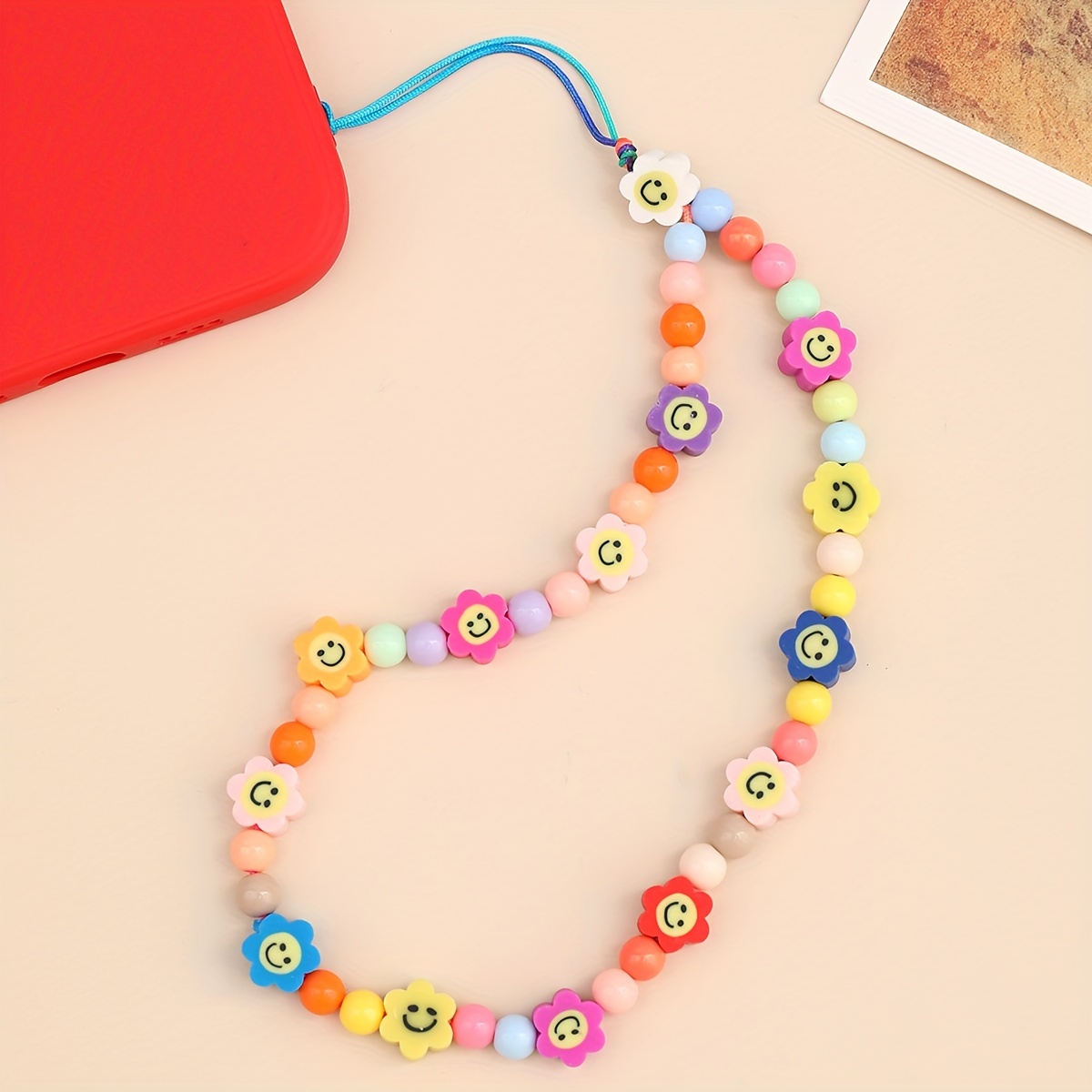 

Muti-color Soft Pottery Happy Face Flower Pattern Mobile Phone Chain